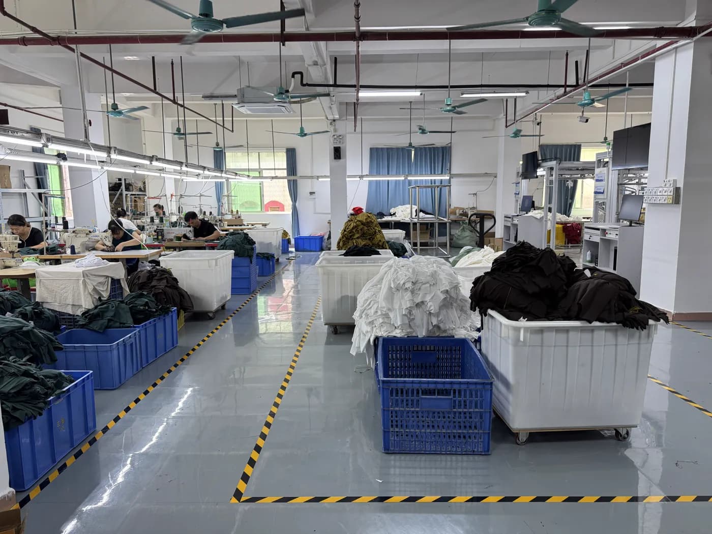 Sewing line with garment bins at Pindon's clothing factory