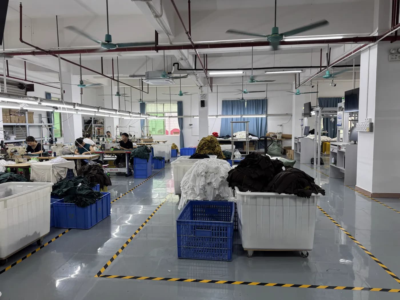 Sewing operators at industrial machines inside Pindon's factory