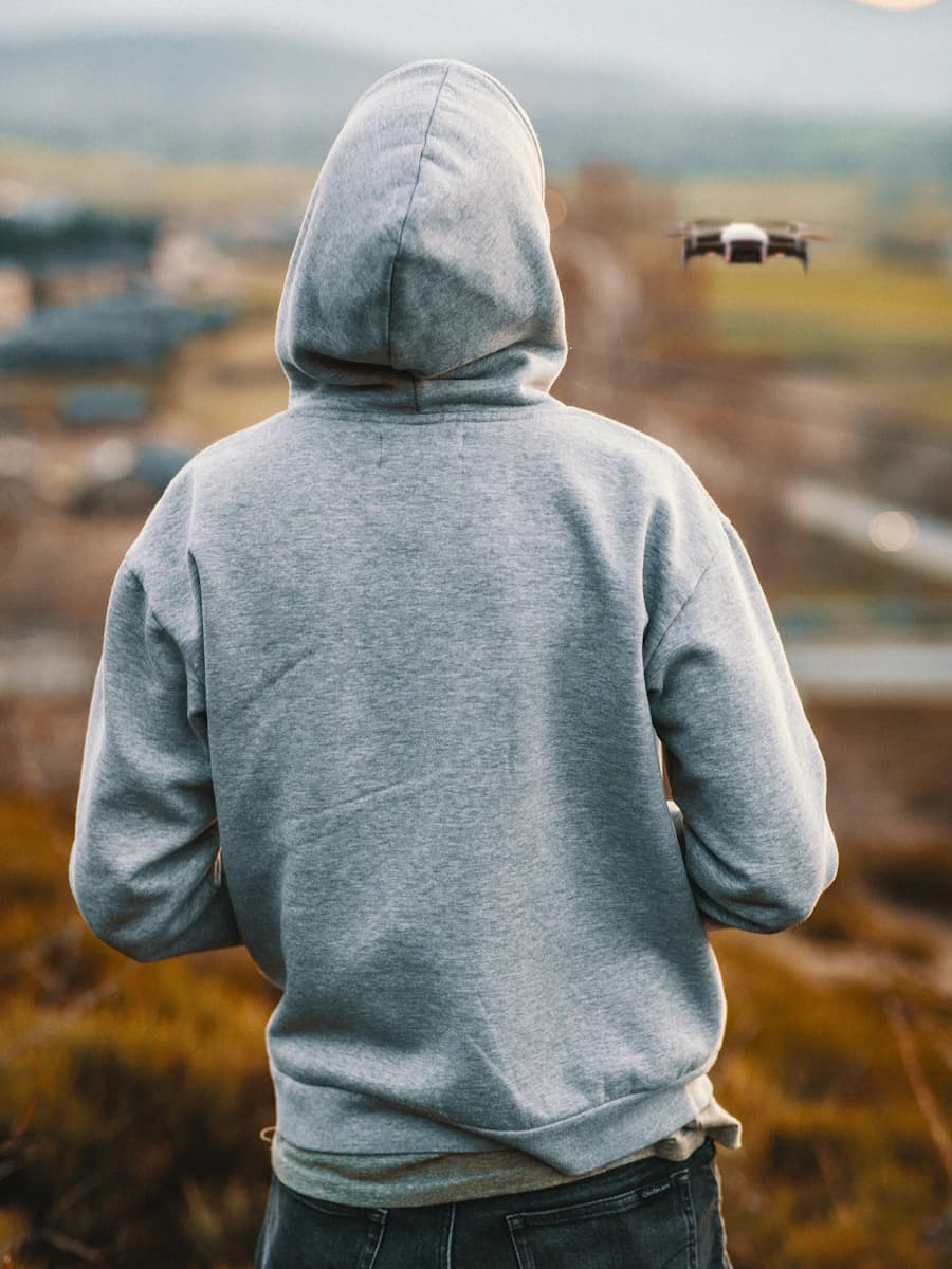 Adult model style reference — man wearing grey pullover hoodie
