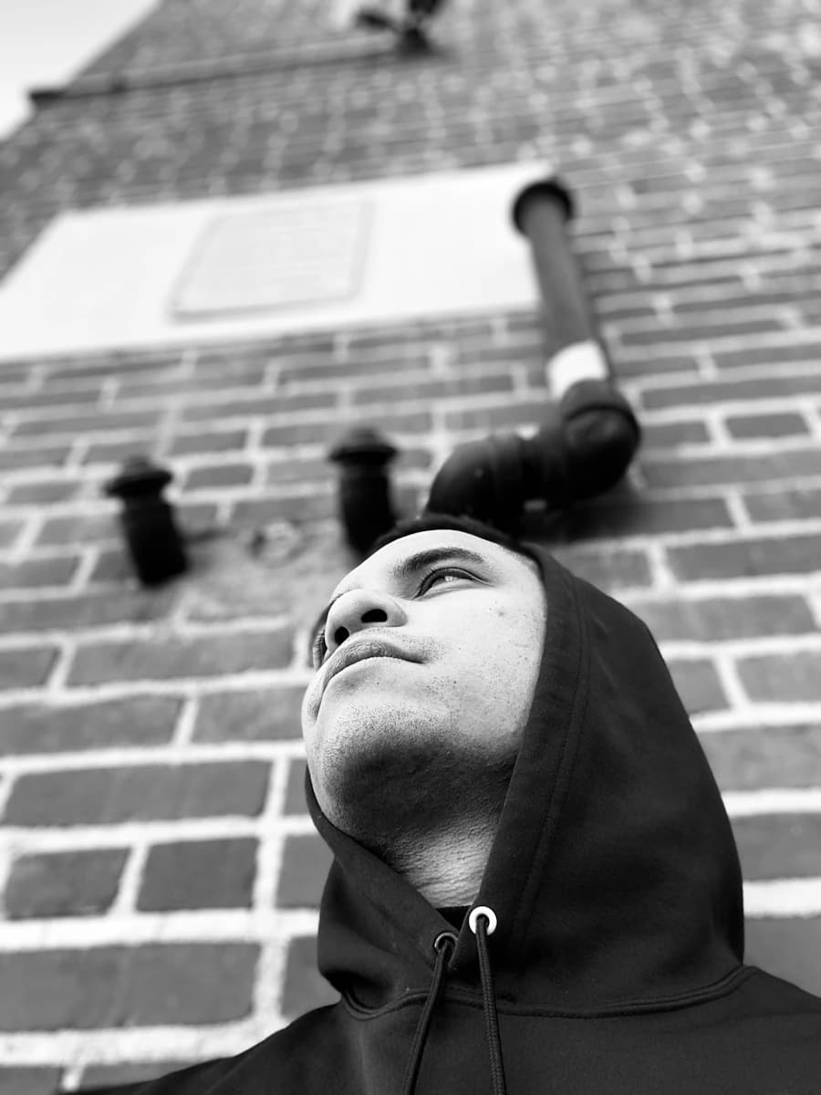 Adult model style reference — grayscale photo of man in black zip up jacket