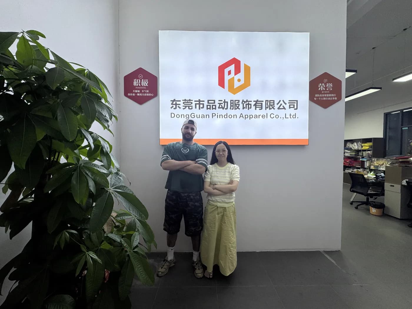 Customers at Dongguan Pindon Apparel's factory entrance