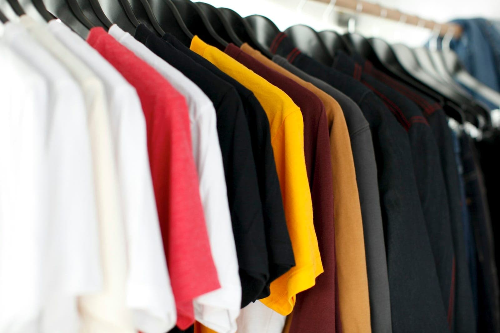 Assorted apparel pieces representing fabric, print, embroidery, and labeling customization options